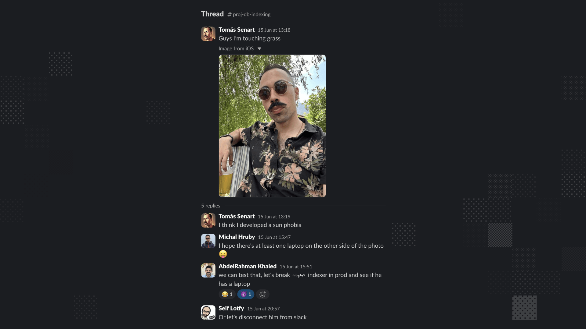 Man with sunglasses and floral shirt touching grass